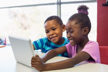 School african american kids using a digital tablet in classroom